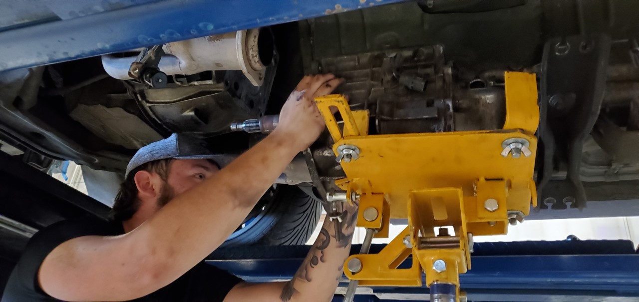 Student installing a manual transmission
